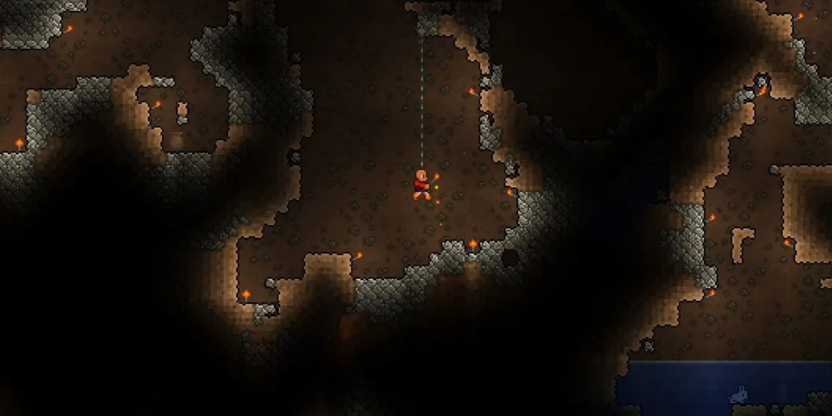 Подземелье Terraria: пещеры, освещённые факелами, и жила руды